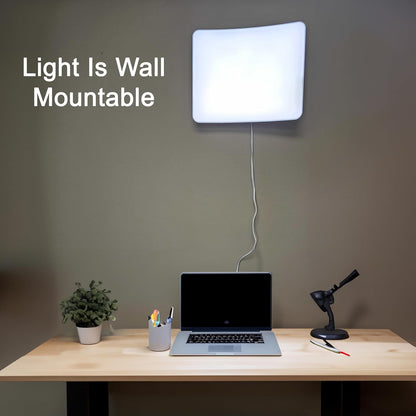 Day-Light Elite light therapy lamp mounted on a wall above a home office desk