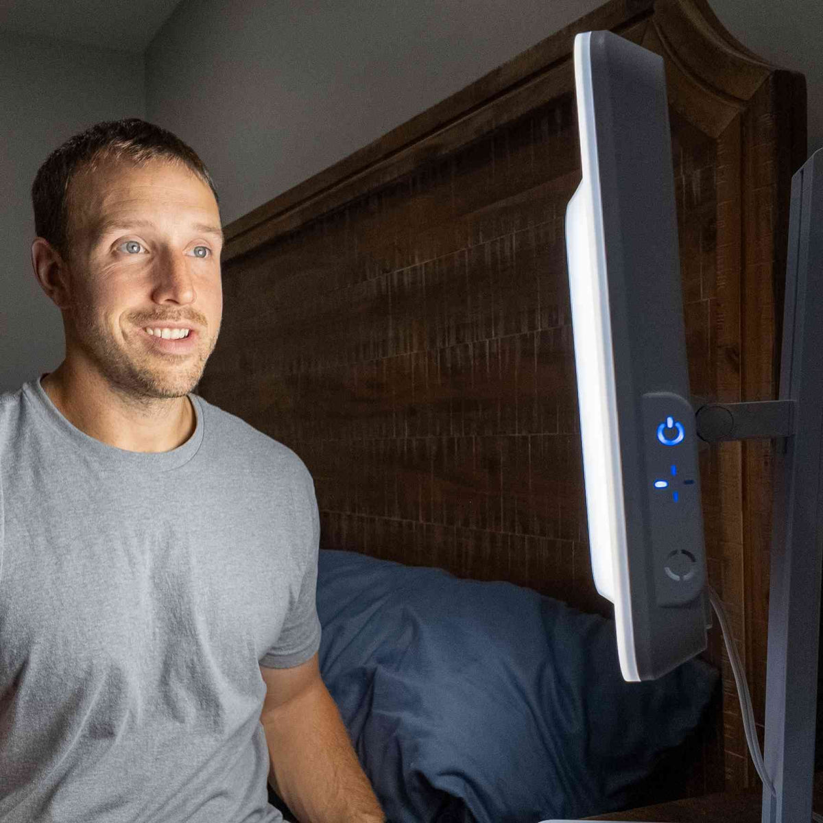 Man smiling during a session with the Day-Light Elite full spectrum light therapy lamp