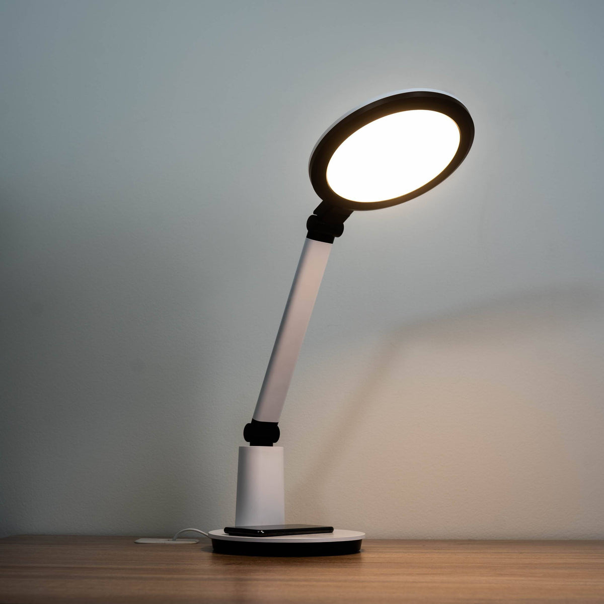 TheraLite Halo stylish light therapy lamp with a round head in a home setting